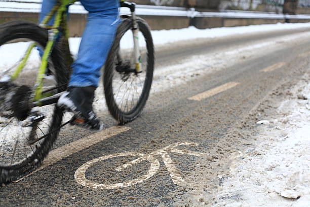 snow-capped bike path and a partial view of a cyclist