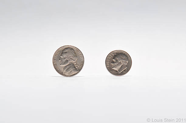 Coins on gray background US Nickel and Dime coins on a gray background  five cent coin stock pictures, royalty-free photos & images