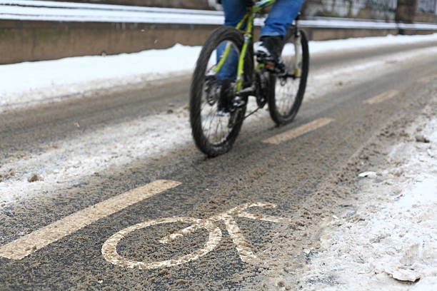 istock snow-capped bike path and a partial view of a cyclist 638047866