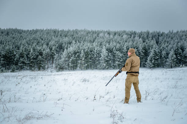 istock Hunter man dressed camouflage clothing standing in the winter 638048854