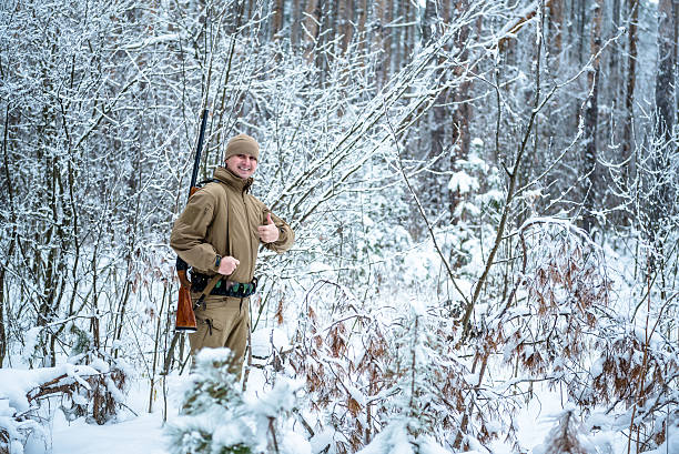 istock Hunter man dressed camouflage clothing standing in the winter 638050588