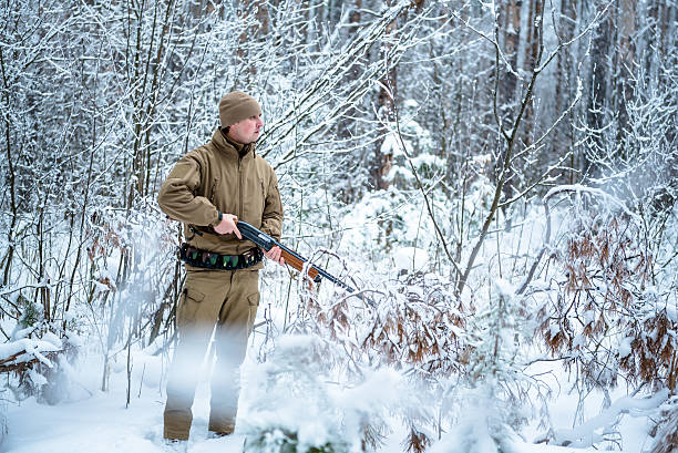 istock Hunter man dressed camouflage clothing standing in the winter 638050680