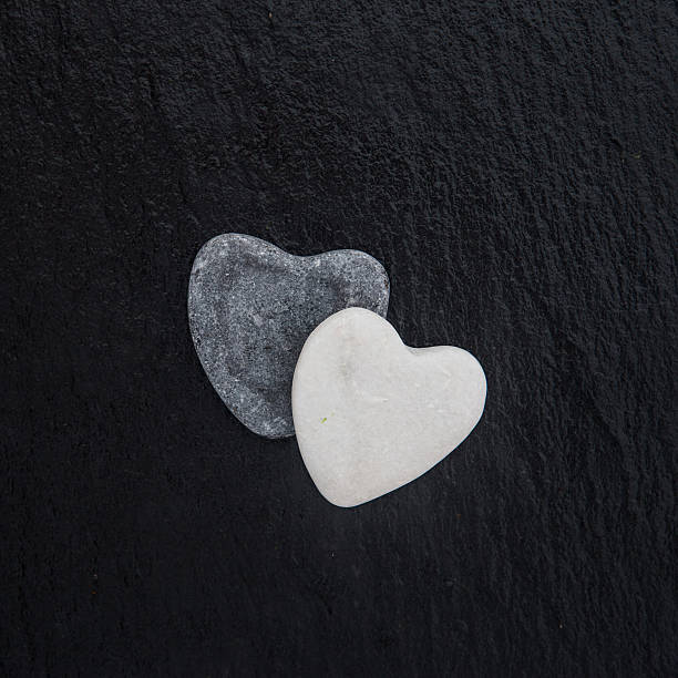 istock Heart-shaped sea stone  on black background 638051202