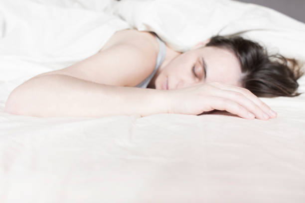 istock Tired young woman sleeping on bed 638051264
