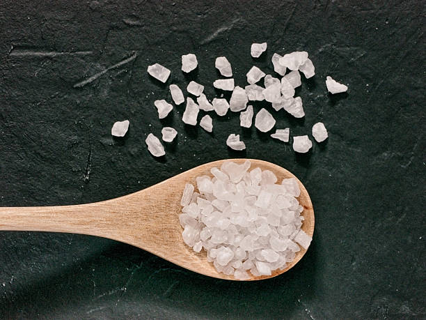 istock coarse sea salt on dark background close up 638054478