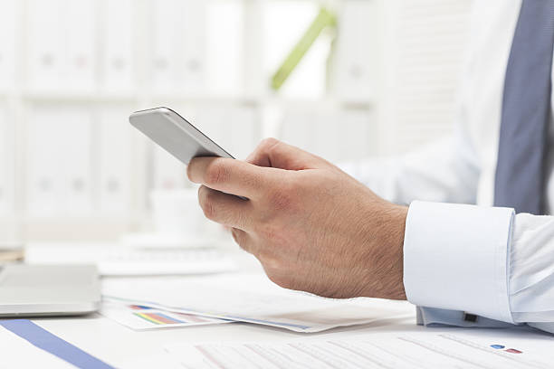 istock Man in gray tie with his cell phone 638055334