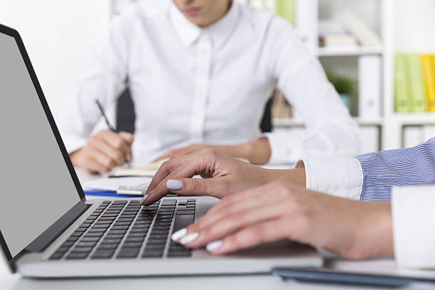 istock Woman with white nails is typing 638055470