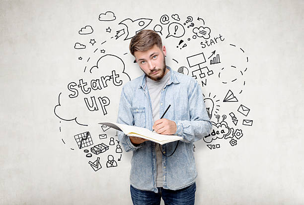 istock Bearded man with notebook near startup sketch 638056536