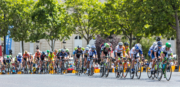 Paris, France - July 24, 2016: The feminine peloton riding on Champs Elysees in Paris during the second edition of La Course by Le Tour de France 2016.