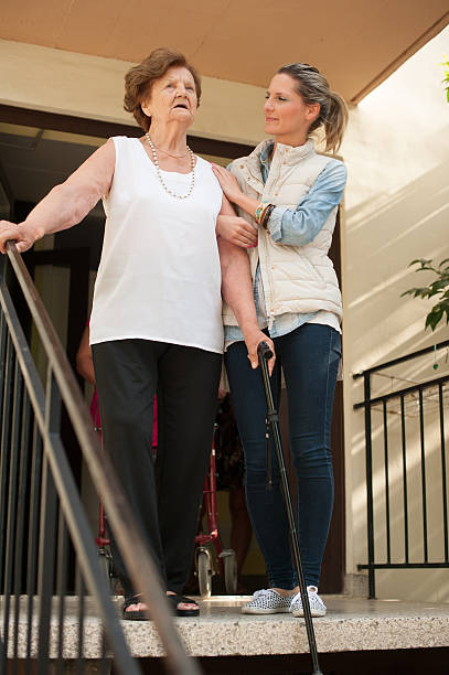 istock Helping an Elderly Woman Walk Downstairs 638057772