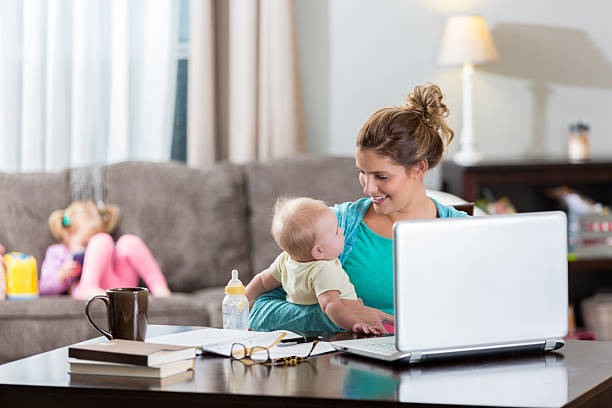 istock Happy mom holds baby while working from home 638058368