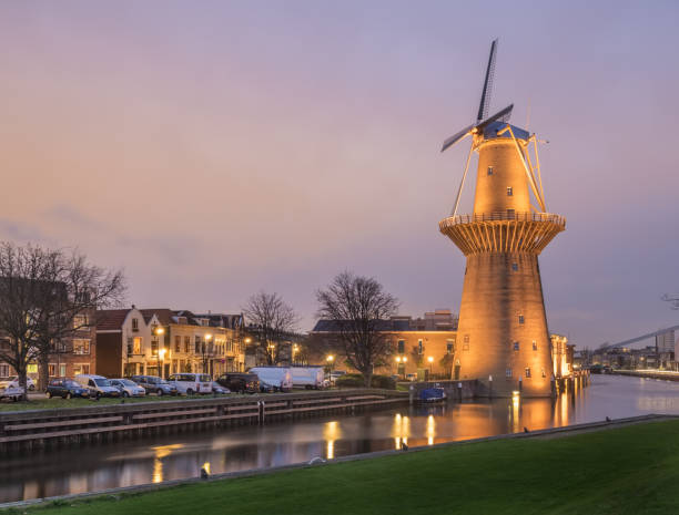 Dutch city Schiedam landscape with reflections canal old windmill stock photo