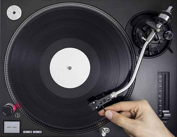 istock DJ Turntable, Hand placing Tonearm on Vinyl Record, Top View 638063126