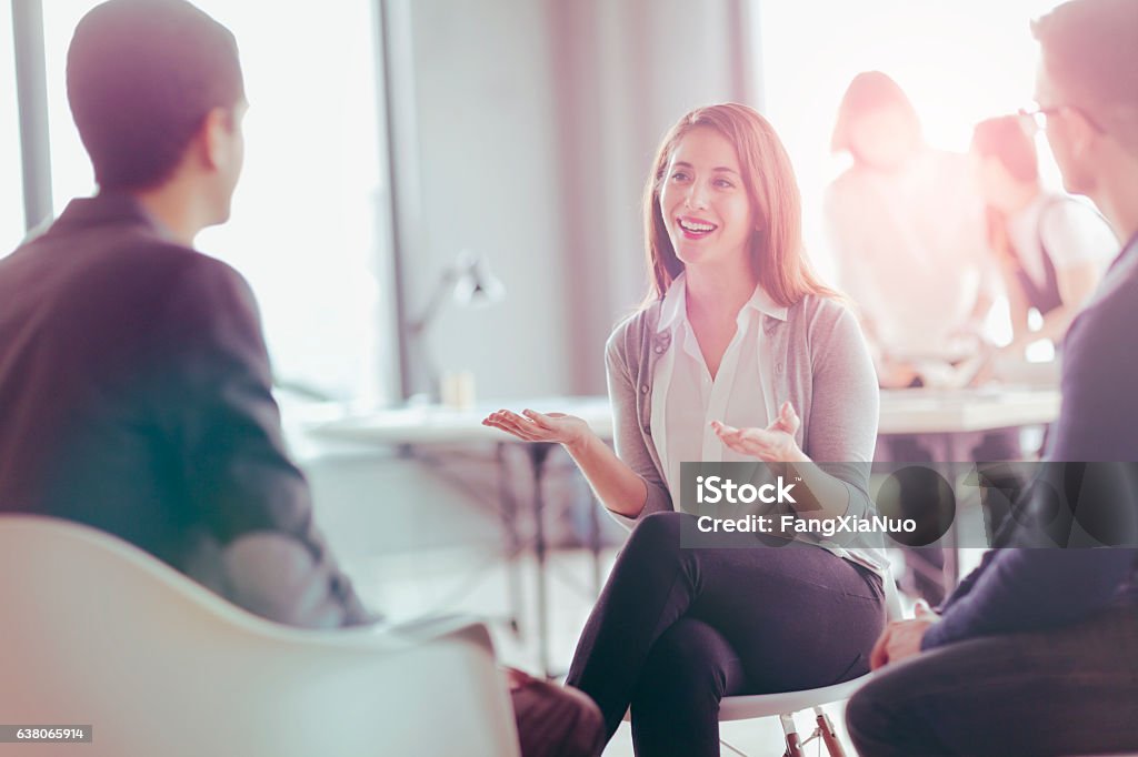 Office coworkers talking during meeting together in design studio Occupation Stock Photo