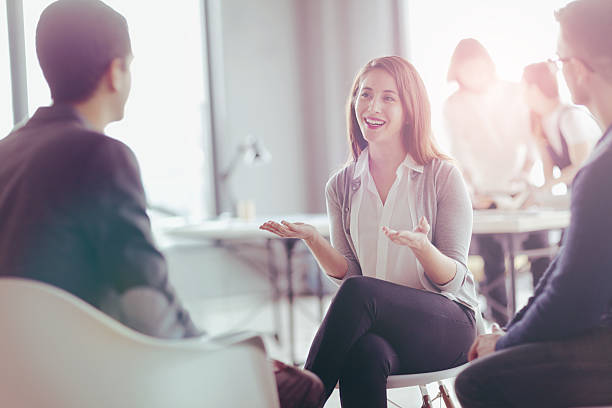 Office coworkers talking during meeting together in design studio Office coworkers talking during meeting together in design studio casual job interview stock pictures, royalty-free photos & images