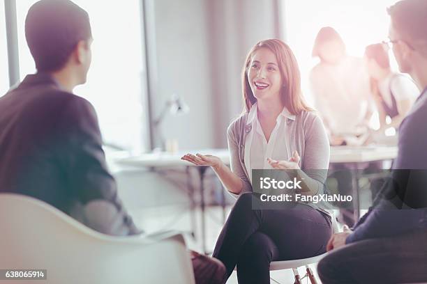 Office Coworkers Talking During Meeting Together In Design Studio Stock Photo - Download Image Now