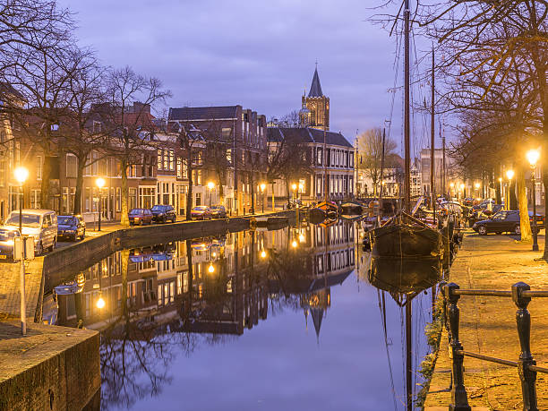 Old Dutch city landscape with canal church reflections stock photo