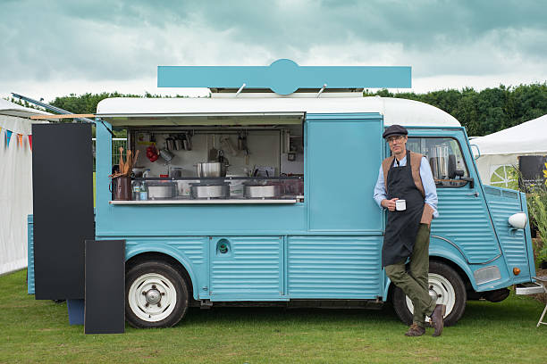 istock Man Standing by a Blue Food Truck 638068880