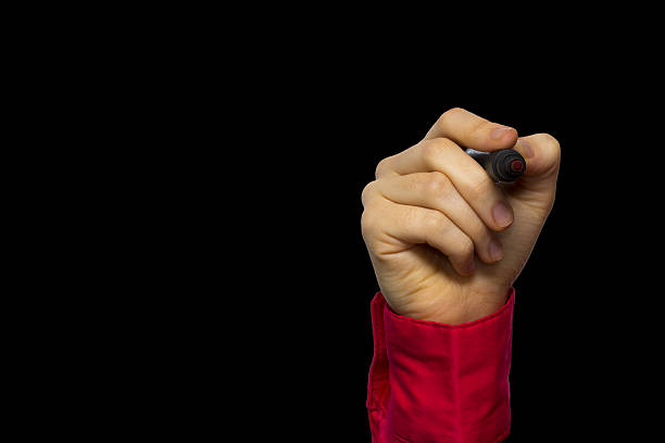 istock Hand holding marker isolated on black 638069760
