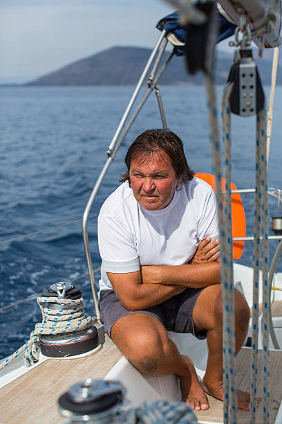 istock Male skipper is sitting on a sailing yacht. 638071642