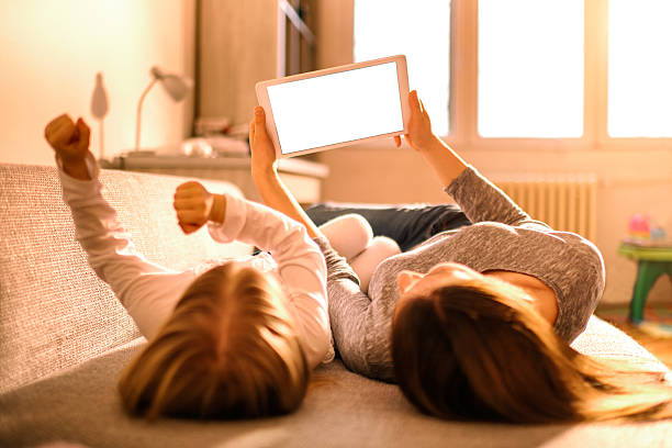 Mother and daughter with digital tablet stock photo