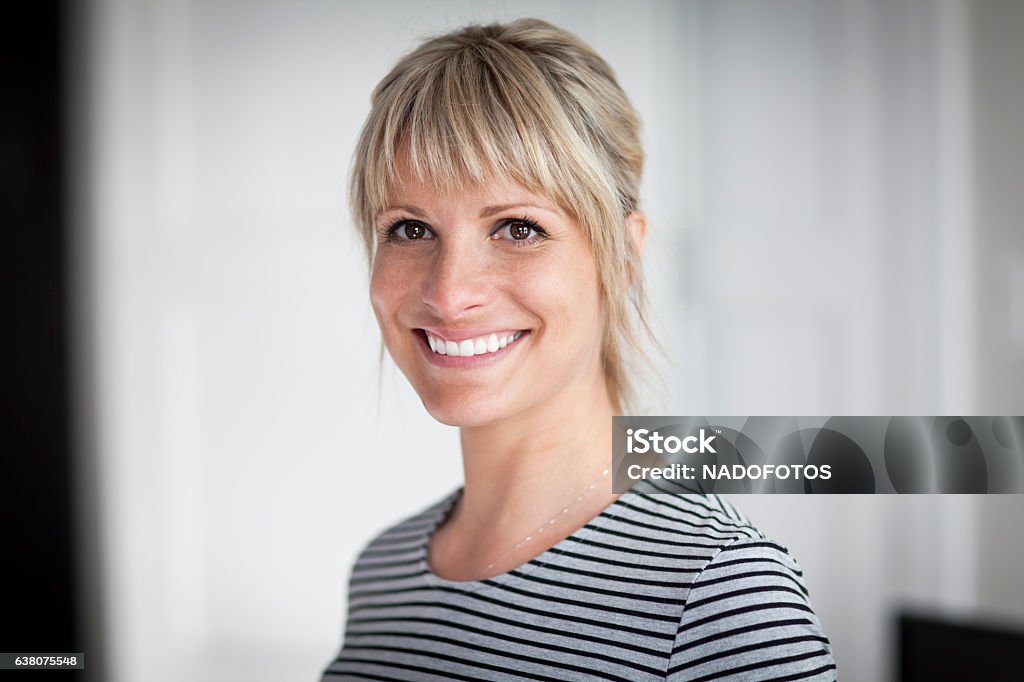 Portrait Of A Mature Woman Smiling At The Camera At Home Women Stock Photo