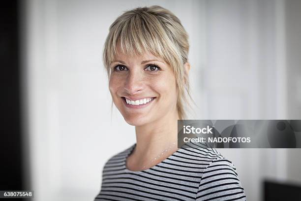 Portrait Of A Mature Woman Smiling At The Camera At Home Stock Photo - Download Image Now