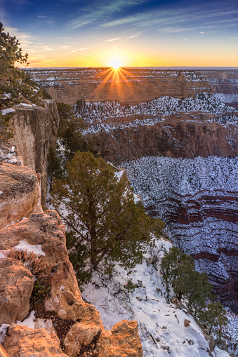 The Grand Canyon, Arizona, basking in the beautiful winter sunset with snow.