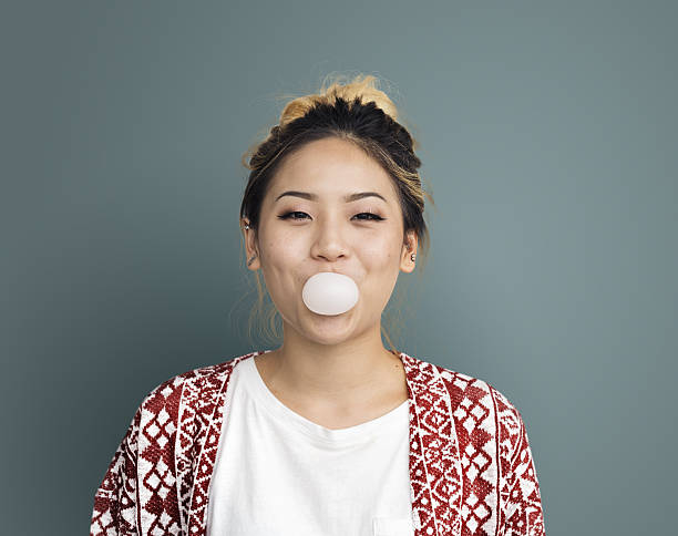 istock Young Girl Chewing Bubble Gum Concept 638084982