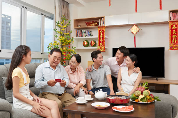 Vietnamese family drinking tea and having fun at Tet celebration