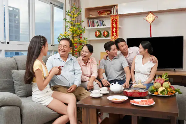 Happy asian family celebrating Chinese New Year at home