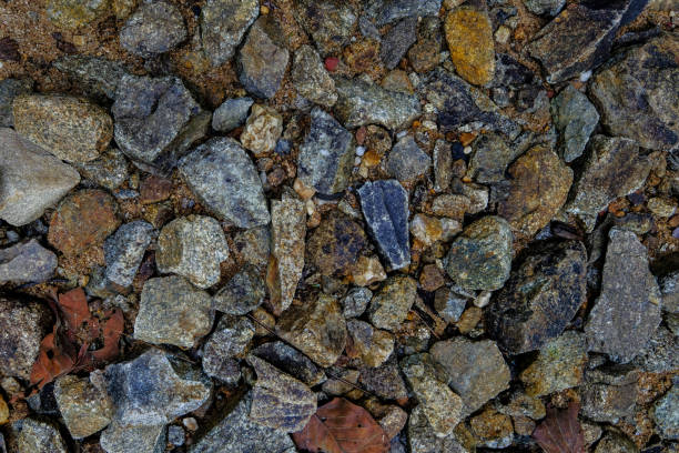 istock Brown stone wall of pebbles, background, texture 638086530