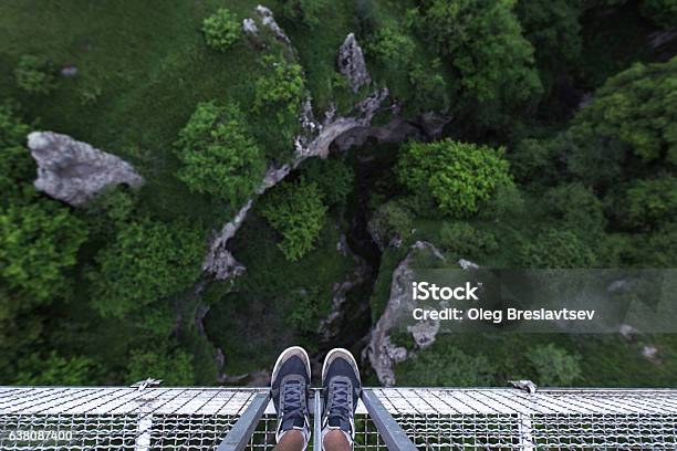 Man Feet Standing On The Edge Of Suspension Bridge Stock Photo - Download Image Now - Cliff, At The Edge Of, Adults Only