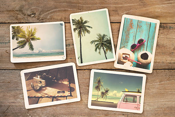 instant photo Summer photo album on wood table. instant photo of vintage camera - vintage and retro style surfing photos stock pictures, royalty-free photos & images