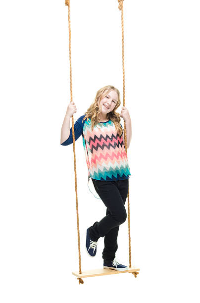 istock Smiling little girl swinging 638089496