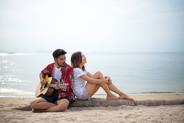 istock Cute hispanic couple playing guitar serenading 638090644