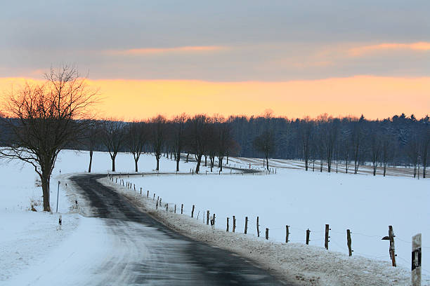 istock Curvy country road in winter me snow 638093144