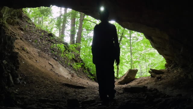 Spelunker Enters Cave with LED Headlamp