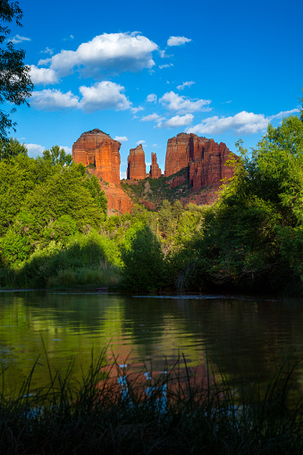 Sedona, AZ, USA - 2016.  A view of Cathedral Rock reflecting off of Oak Creek just before a summer sunset.