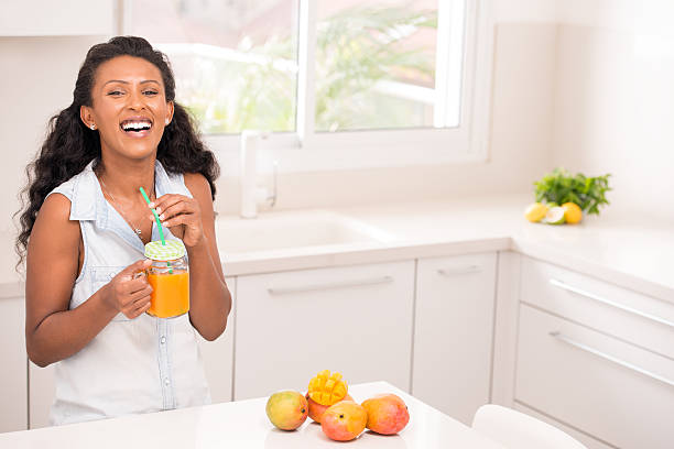 istock Woman enjoying mango smoothie. 638099292