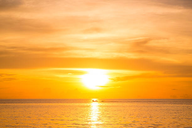 istock fisherman boat and beautiful sunset at golden time 638100878