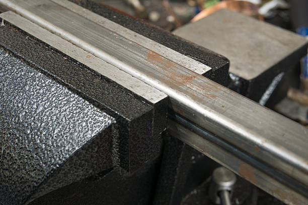 istock Bench vise locking a square steel tube 638100896