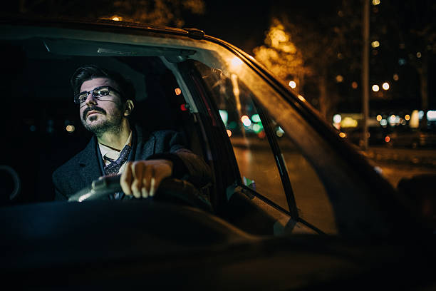 istock Man driving a car at night 638101394