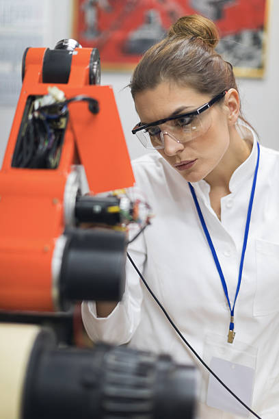 istock Female electrician inspecting circuit board on machine 638103670