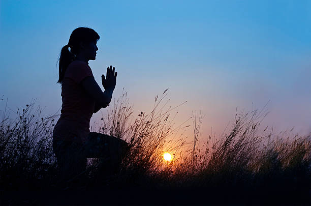 istock Woman practicing yoga on the blue sunset background 638106378