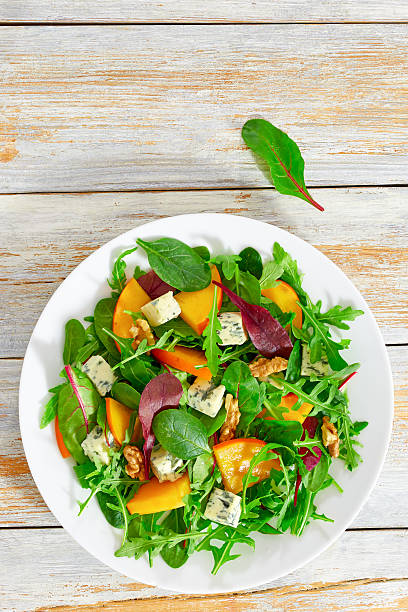 istock persimmon, blue cheese, spinach, arugula, lettuce leaves and wal 638106828