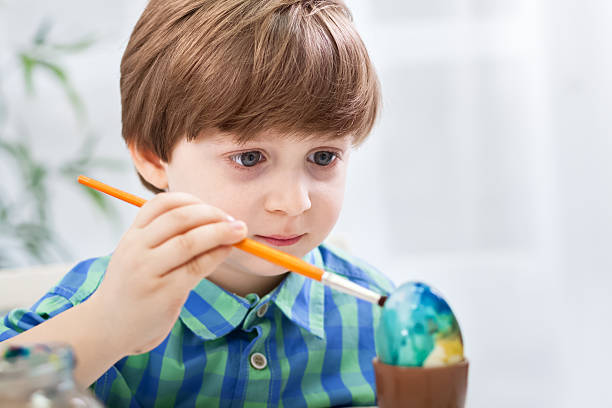 istock Close up of child boy coloring easter egg 638107022