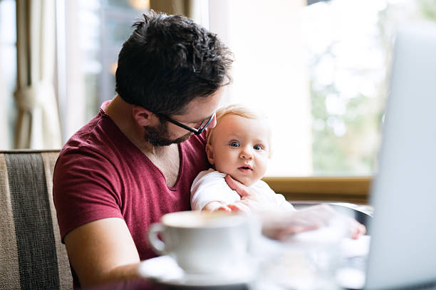 istock Man with notebook in cafe drinking coffee, holding his son 638108000