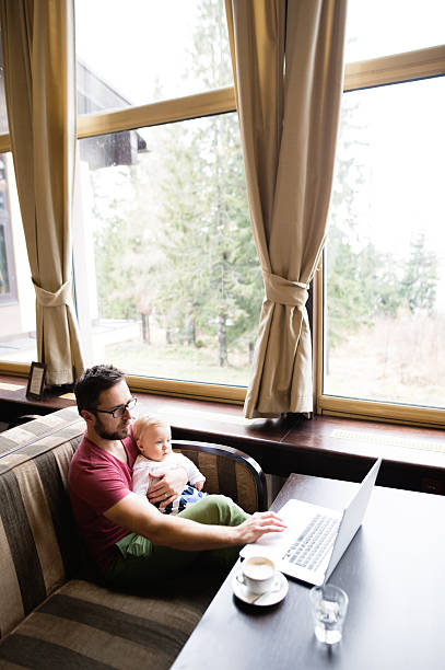 istock Man with notebook in cafe drinking coffee, holding his son 638108042