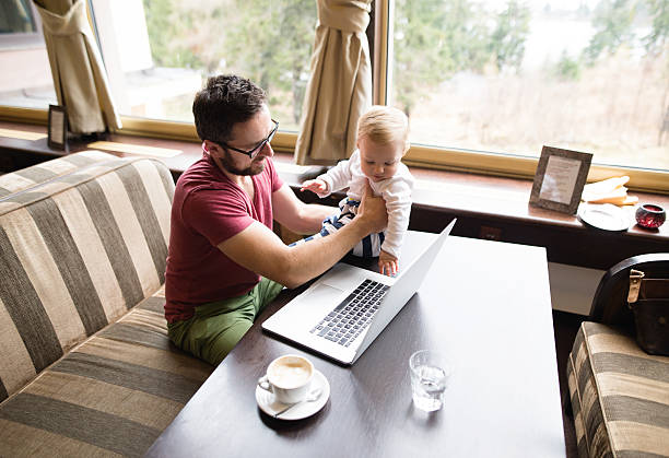 istock Man with notebook in cafe drinking coffee, holding his son 638108096